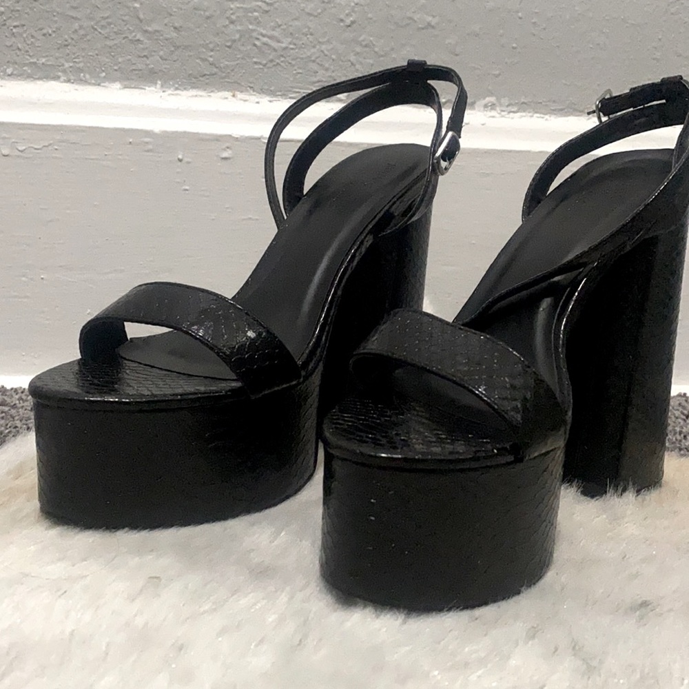 Never been worn. 5in black platform heels. Black snake print material. Size 7.5